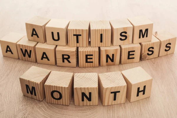 autism awareness month words made of wooden cubes