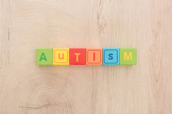 Top View Autism Lettering Made Multicolored Cubes Wooden Table — Stock Photo, Image