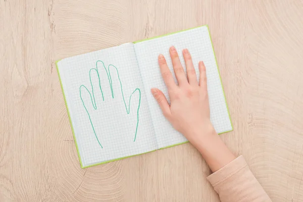 裁剪视图的女性手打开笔记本与绘制的人类手掌 — 图库照片