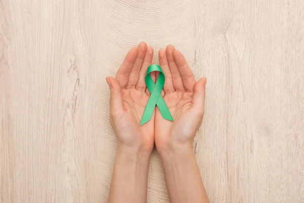 Partial View Woman Holding Green Ribbon Wooden Background — Stock Photo, Image