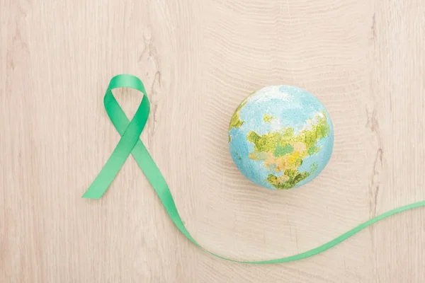 Top View Bright Toy Earth Green Ribbon Wooden Background — Stock Photo, Image