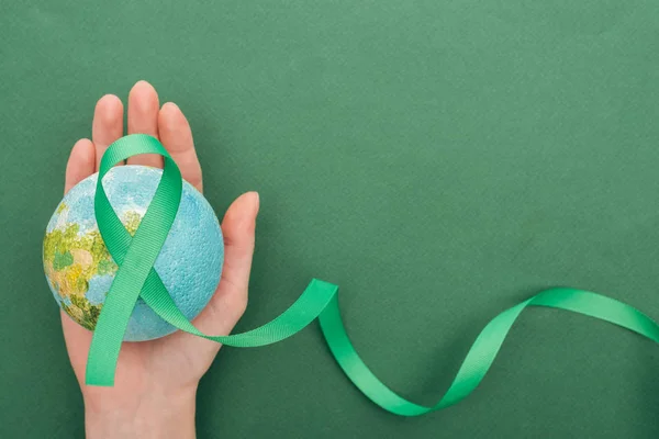 Partial View Woman Holding Toy Earth Ribbon Green Background — Stock Photo, Image