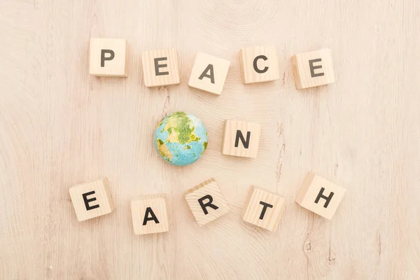 Top View Cubes Peace Earth Lettering Toy Planet Wooden Background — Stock Photo, Image