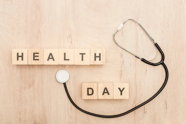 Top View Cubes Health Day Lettering Stethoscope Wooden Background — Stock Photo, Image