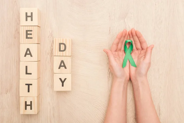 Partial View Woman Holding Green Ribbon Cubes Health Day Lettering — Stock Photo, Image