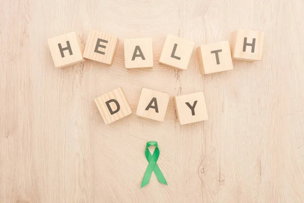 Top View Green Ribbon Cubes Health Day Lettering Wooden Background — Stock Photo, Image