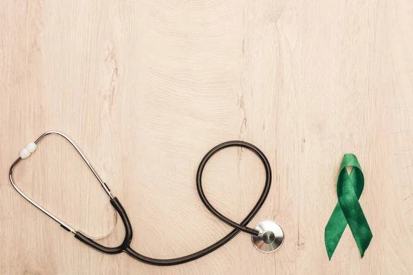 Top View Stethoscope Green Ribbon Wooden Background Copy Space — Stock Photo, Image