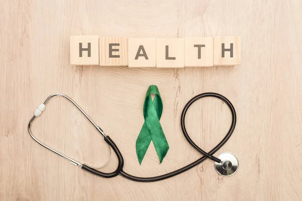 Draufsicht Auf Würfel Mit Gesundheitsaufdruck Stethoskop Und Grünem Band — Stockfoto