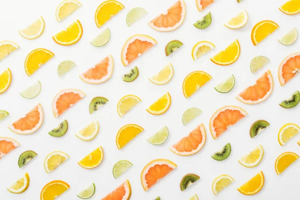 Flat lay with juicy cut fruits on white surface