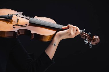 partial view of woman with tattoo playing cello isolated on black clipart