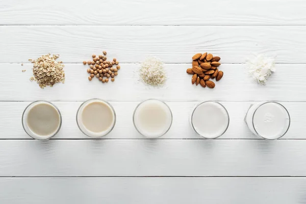 Top View Glasses Coconut Chickpea Oat Rice Almond Milk Wooden — Stock Photo, Image