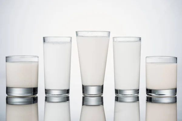 Row Glasses Organic Fresh Alternative Milk Grey Background Reflection — Stock Photo, Image