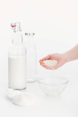 cropped view of woman putting rice in bowl while cooking rice vegan milk clipart