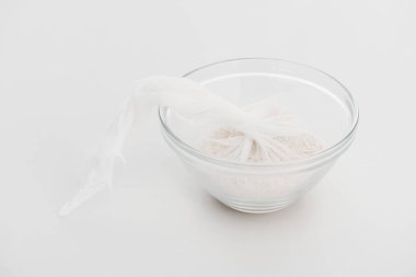 rice in cheesecloth in glass bowl on grey background clipart
