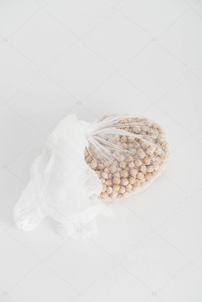 Chickpea in white cheesecloth on grey background