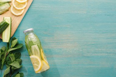 top view of detox drink in bottle with lemon and cucumber slices and mint  clipart