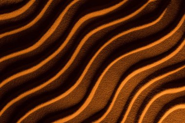 top view of textured sand with waves and orange color filter clipart