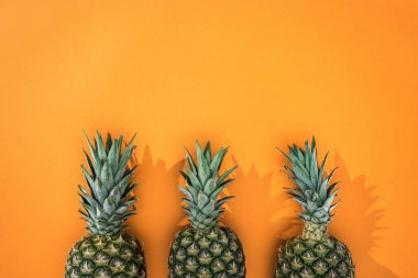 kopya alanı ile turuncu arka plan üzerinde ananas üst görünümü