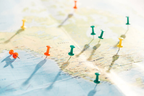selective focus of world map with colorful push pins