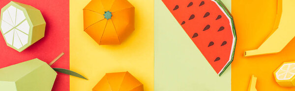 panoramic shot of various handmade origami fruits on colorful paper stripes
