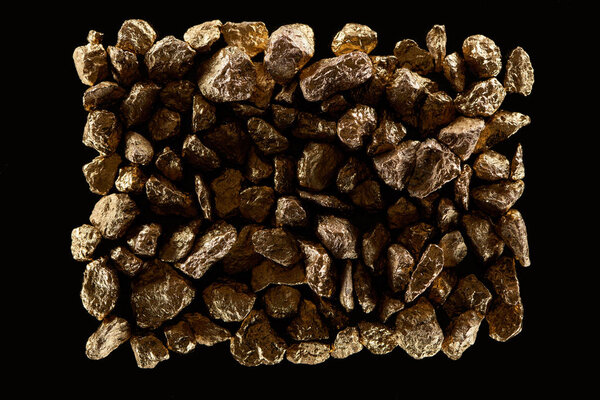 top view of gold stones in pile isolated on black