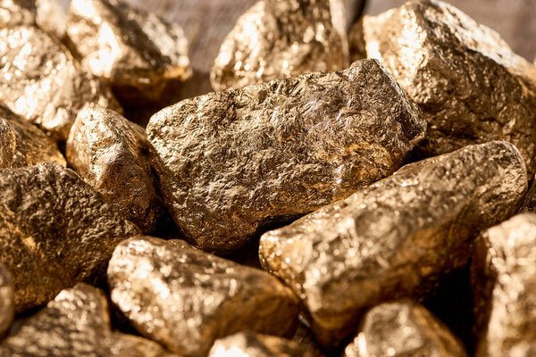 close up view of golden textured shiny stones in sunlight