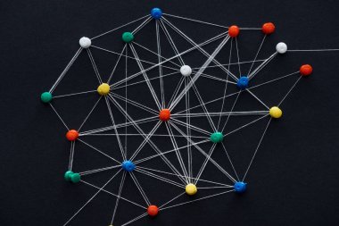 top view of push pins connected with strings isolated on black, network concept clipart