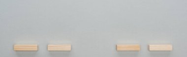 panoramic shot of wooden blocks isolated on grey with copy space clipart