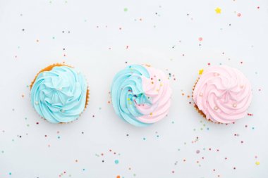 panoramic shot of tasty colorful cupcakes with sprinkles Isolated On White clipart