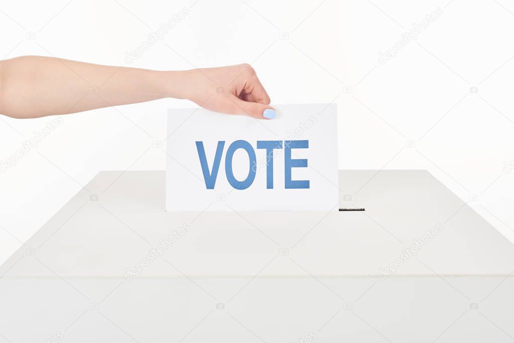 cropped view of woman putting vote in box isolated on white