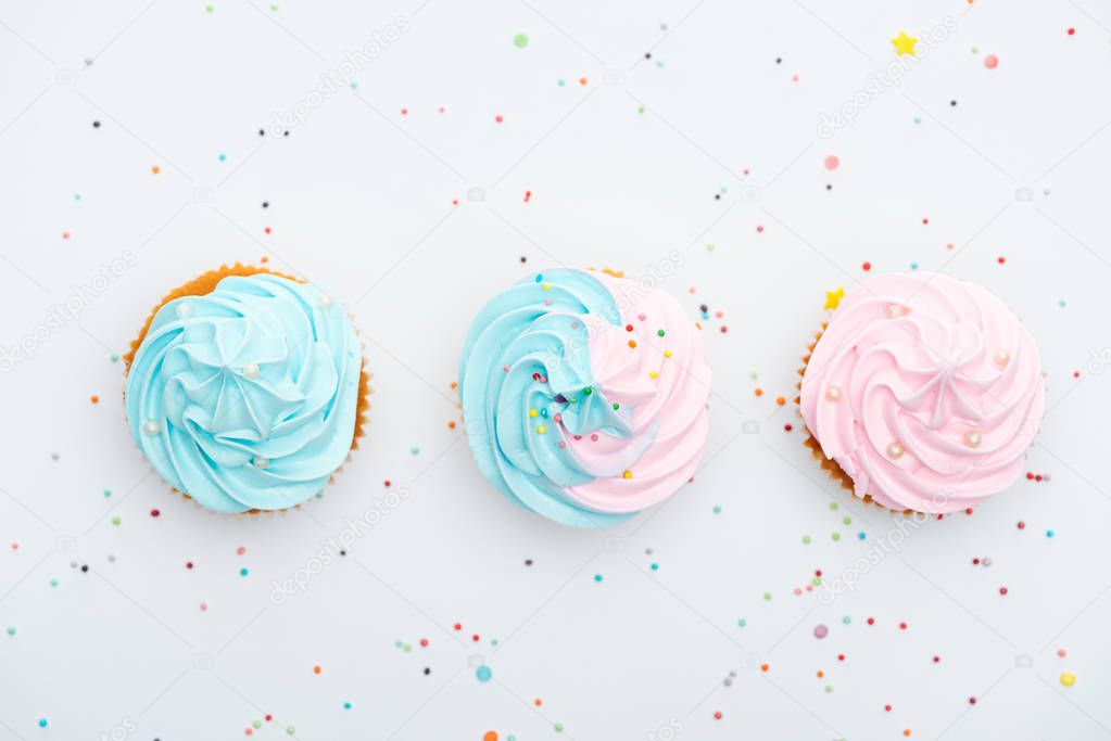 panoramic shot of tasty colorful cupcakes with sprinkles Isolated On White