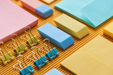 close up view of colorful office stationery supplies on yellow clipart