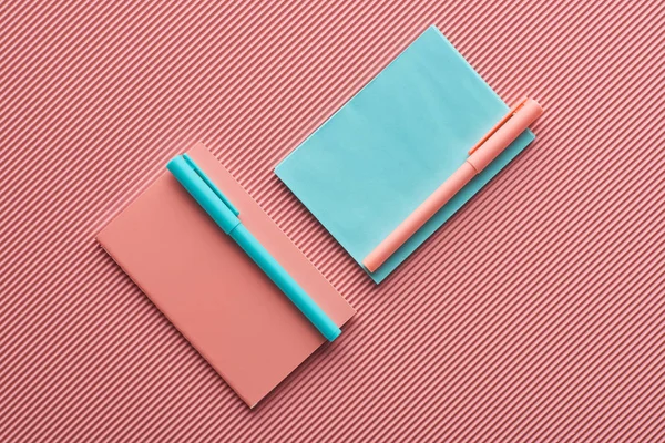 Top View Pens Notebooks Textured Pink — Stock Photo, Image