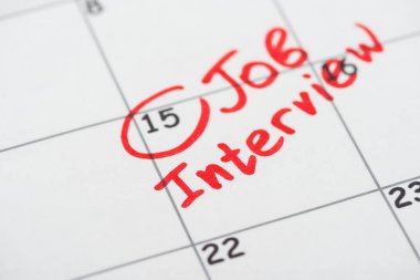 close up view of print calendar with red mark and job interview lettering clipart