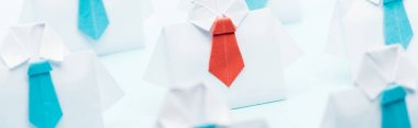 panoramic shot of origami white shirts with blue ties with one red, think different concept clipart