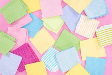 top view of messy scattered multicolored rags on pink background clipart