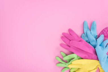 top view of multicolored rubber gloves on pink background with copy space clipart