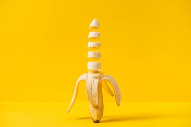 Sliced nutritious tasty fresh banana isolated on yellow clipart