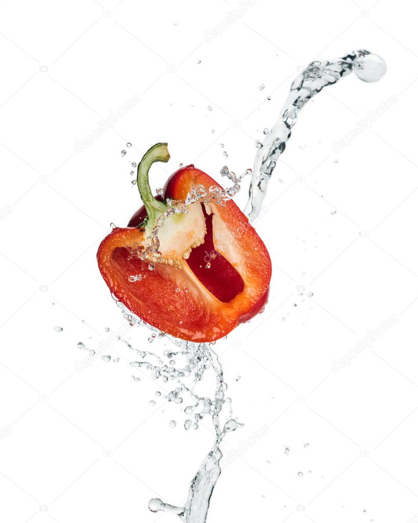 red bell pepper half with clear water splash and drops isolated on white