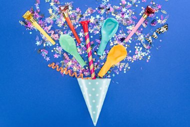 Top view of party colorful decoration on blue background, surprise concept clipart