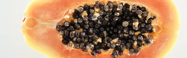 panoramic shot of ripe exotic papaya half with black seeds isolated on white