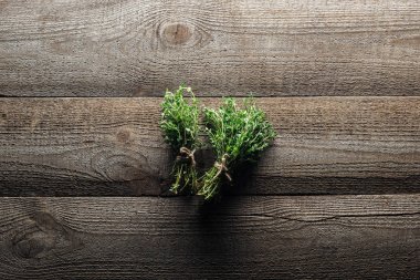 top view of green thyme on wooden weathered table clipart