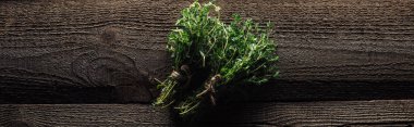 top view of green fresh thyme on wooden brown rustic table, panoramic shot clipart