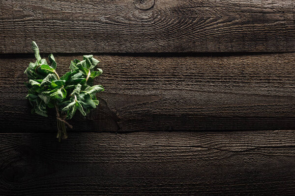 top view of green fresh mint on wooden rustic table