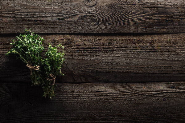 top view of green thyme on wooden weathered table with copy space