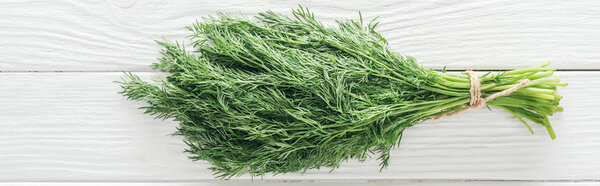 top view of fresh green dill on white wooden table, panoramic shot