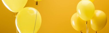 festive bright minimalistic balloons on yellow background, panoramic shot clipart