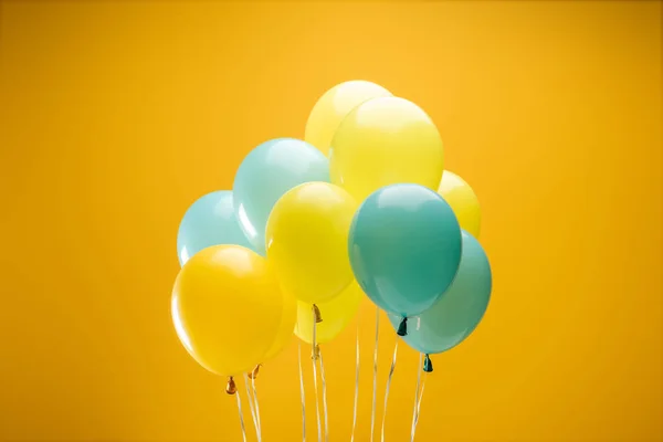 Świąteczne Ozdobne Niebieskie Żółte Balony Żółtym Tle — Zdjęcie stockowe