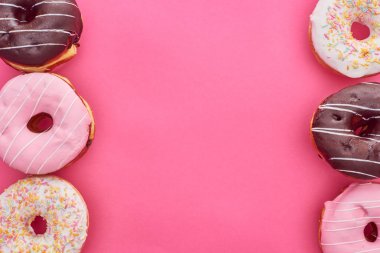 top view of delicious glazed doughnuts on bright pink background clipart