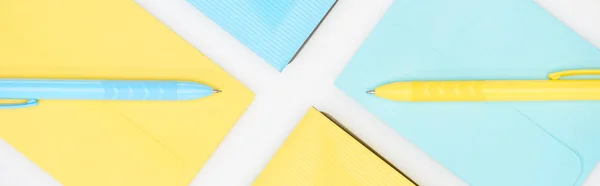 Panoramic Shot Blue Yellow Folders Envelopes Pens Isolated White — Stock Photo, Image